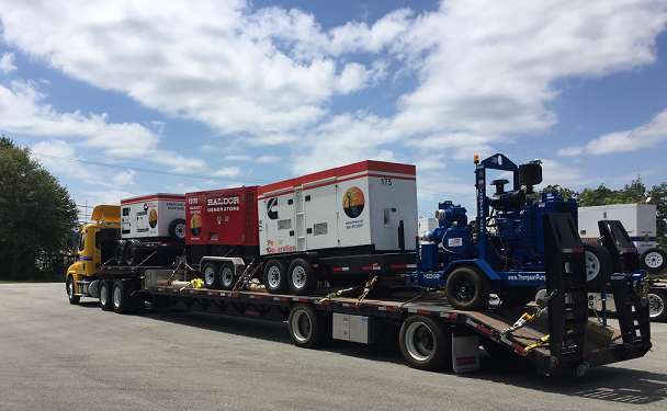 A truck carrying generators prepares to leave. 